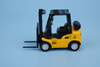 Yellow forklift on blue background