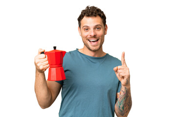 Canvas Print - Brazilian man holding coffee pot over isolated chroma key background pointing up a great idea