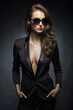 fashion portrait of Beautiful woman in sunglasses and suit. Business lady