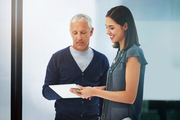 Canvas Print - Businessman, tablet and discussion with colleague for research, data or online browsing at office. People or employees talking with technology in conversation or communication on project at workplace