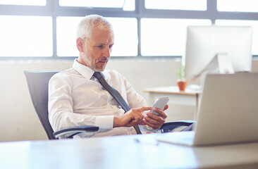 Poster - Laptop, phone and businessman in office reading company email online for communication. Research, technology and professional mature male attorney networking on internet with cellphone in law firm.