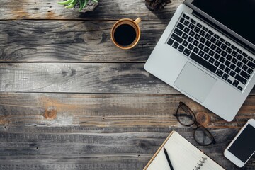 Canvas Print - Top view of a tidy, contemporary workspace featuring a laptop, coffee mug, and notebook on a rustic wooden surface