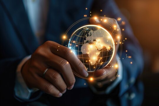 A man in a suit holding a glowing globe. Suitable for business and global concepts