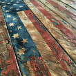 Patina-finished vintage American flag on teak wood  Memorial Day.