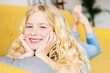 Happy portrait of cute girl 6 year old relaxing on sofa at home. Young little female child smiling at camera at home. Childhood and innocence children concept.