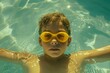 Portrait of a child with yellow swimming goggles in sunlit water