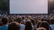 © Attasit - Crowds of supporters filling a town square, eagerly watching the big screen with excitement and anticipation during a public viewing event.