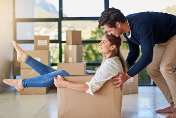 Sticker - Happy couple, box and moving in new home with fun for investment, property or apartment together. Young man pushing woman with boxes and playing in house for relocation, renovation or mortgage loan