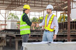 © JU.STOCKER - Engineers shaking hands at construction site, Construction workers handshake with factory foreman worker at the precast factory site
