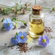 Flax essential oil with flax flower on concrete backgorunds