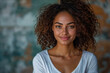 © Spicy World - Young woman with curly hair posing against blue textured background, for marketing campaign