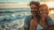 © ORG - happy mature man being hugged by his wife at the beach, young couple having fun at the sea shore