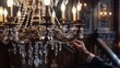 © Parintron - A hand adjusting the crystals on a chandelier.