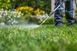 closeup of worker carefully spraying pesticide on lush green lawn professional outdoor pest control service environmental maintenance