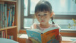 little asian child girl reading a book