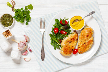 Canvas Print - fried chicken breasts with green salad on plate