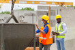 © JU.STOCKER - Engineer man and builders team in hardhats discussing on construction site, Foreman and worker checking project at the precast factory site