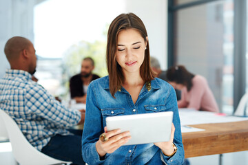 Wall Mural - Happy woman, creative and research with tablet for development, data or innovation on agenda at office. Young female person, designer or employee browsing on technology in online startup at workplace