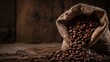 © fivan - Close up of roasted coffee beans spilling out of a burlap sack