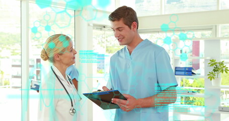 Poster - Image of medical data processing over caucasian male and female doctors discussing at hospital