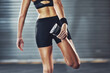 © peopleimages.com - Woman, legs and stretching muscle for gym training with mobility practice, flexibility or challenge. Female person, sportswear and shoes for healthy wellness with fitness athlete, cardio or sport