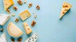 Assorted cheese wedges with walnuts on light blue background. Flat lay food photography. Cheese tasting and pairing concept. Design for food magazine, poster, banner.