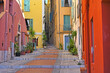 Narrow street with stairs and old buildings in Menton France