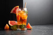 Iced tea or a summer refreshing drink with ice, mint, and grapefruit.