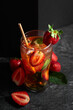 Summer refreshing drink with ice, mint, and strawberries.