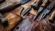© Parintron - The image is of a leatherworker's tools, including a hammer, awl, knife, and stitching tools