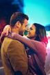 © peopleimages.com - Street, couple and date in night, hug or embrace, love and anniversary together. Outdoor, woman and partner with man, road and relationship with person in city, care and smile for romance in New York
