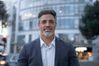 © Stock 4 You - Mature hispanic senior business man standing on busy city street. Headshot close up portrait of Indian or latin confident good looking middle age male entrepreneur businessman happy smiling at camera.