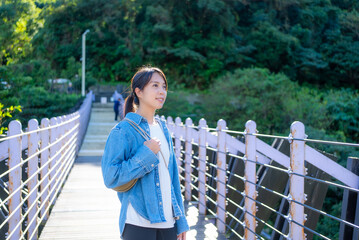 Canvas Print - Woman walk over the suspension bridge at outdoor