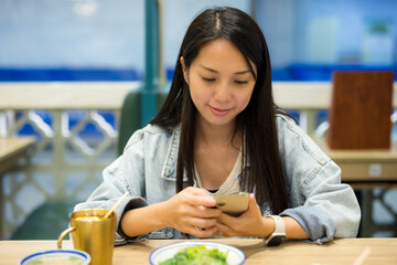 Canvas Print - Woman use mobile phone in the restaurant