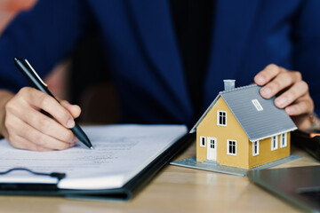 Wall Mural - Interest and loan concept, woman is calculating house interest with documents.