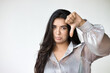 Angry South Asian Indian Woman Expressing Disagreement with thumb down hand Gesture, concept image of Wrong, Rejection, no way, bad, deny, refuse, disagree, dislike, Unhappy and Negative expression