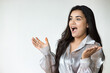 excited south asian woman shouting wow with surprised facial expression to blank space