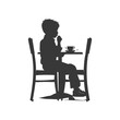 © NikahGeh - Silhouette little boy sitting at a table in the cafe black color only