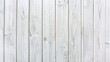 The image shows a white wooden fence made of vertical planks