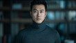 © Руслан Галиуллин - portrait of serious dark-haired man of Asian origin in gray turtleneck on blurred background
