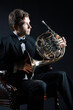 French horn player. Hornist playing brass instrument