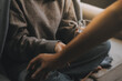 © ARMMY PICCA - Upset woman frustrated by problem with work or relationships, sitting on couch, embracing knees, covered face in hand, feeling despair and anxiety, loneliness, having psychological trouble
