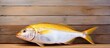 Raw dorado fish on wooden background with copy space image