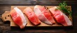 Copy space image of raw red fish steaks arranged on a rustic wooden cutting board ready to be cooked