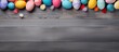 A colorful Easter banner with cut out paper eggs on a grey wooden desktop perfect as a header for websites articles and blogs on Easter decor Includes copy space for customization Top view