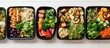 © StockKing - There is a copy space image of a variety of healthy food dishes for dieting The meals are delivered daily in foil boxes placed on white wood The package includes vegetables meat and salads arranged i