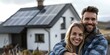 © Anastasiia - Ecstatic couple smiling in front of home adorned with solar panels. Concept Outdoor Photoshoot, Joyful Portraits, Sustainable Lifestyle, Couple Photography, Solar Energy