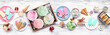 Cool summer food table scene. Assortment of ice cream, popsicles and frozen treats. Pastel colors. Above view on a white wood banner background.