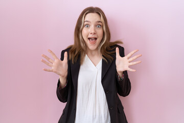 Wall Mural - Young caucasian business woman wearing black jacket celebrating crazy and amazed for success with arms raised and open eyes screaming excited. winner concept