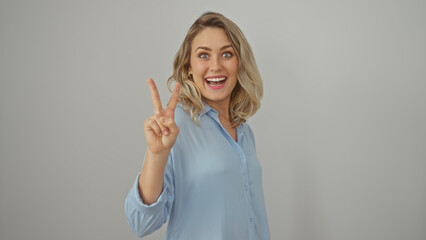 Sticker - A young, attractive, blonde woman in a blue shirt flashes a peace sign, radiating positivity against a white background.